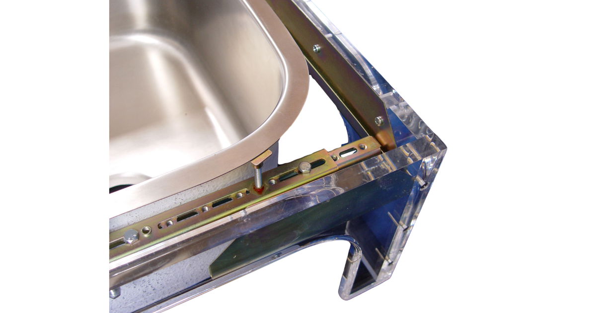 Up close photo of corner of sink setter PW-114-P with sink in place, adjustable metal brackets, bolts and screws, set in an acrylic base for visibility