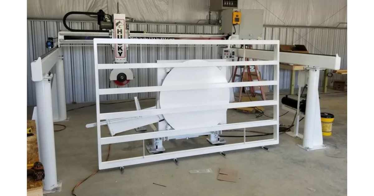 The Husky Bridge Saw, made in the USA by Rye Corp, is a stone slab cutting saw that features a 20 HP motor and can accommodate blades up to 18 inches.